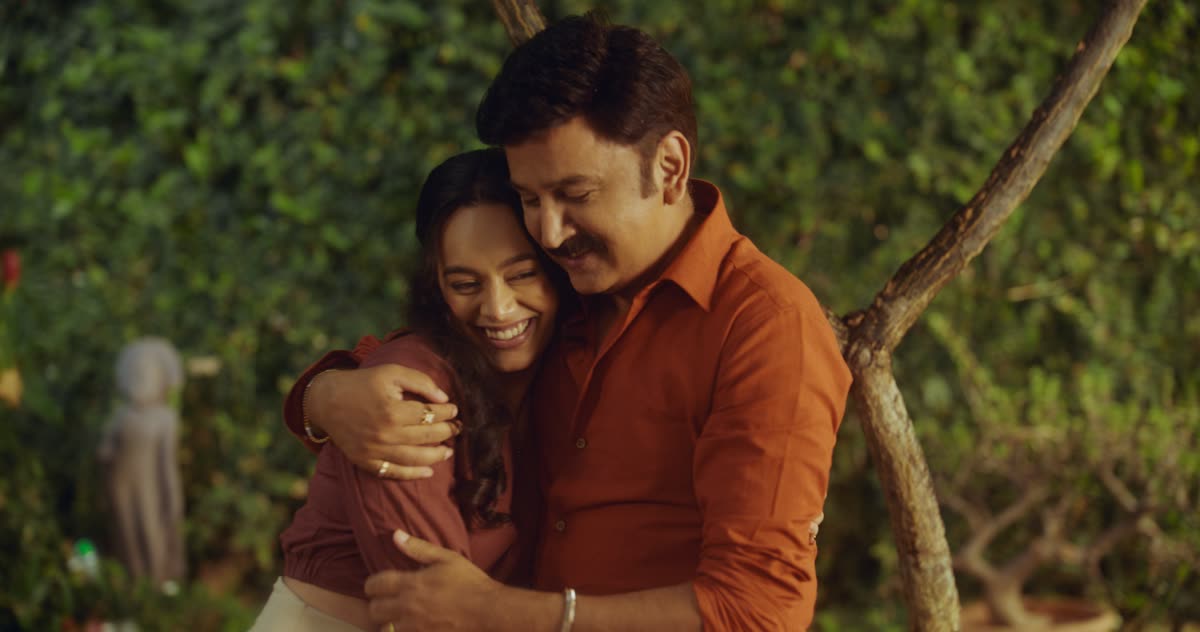 A father hugs his daughter in a garden