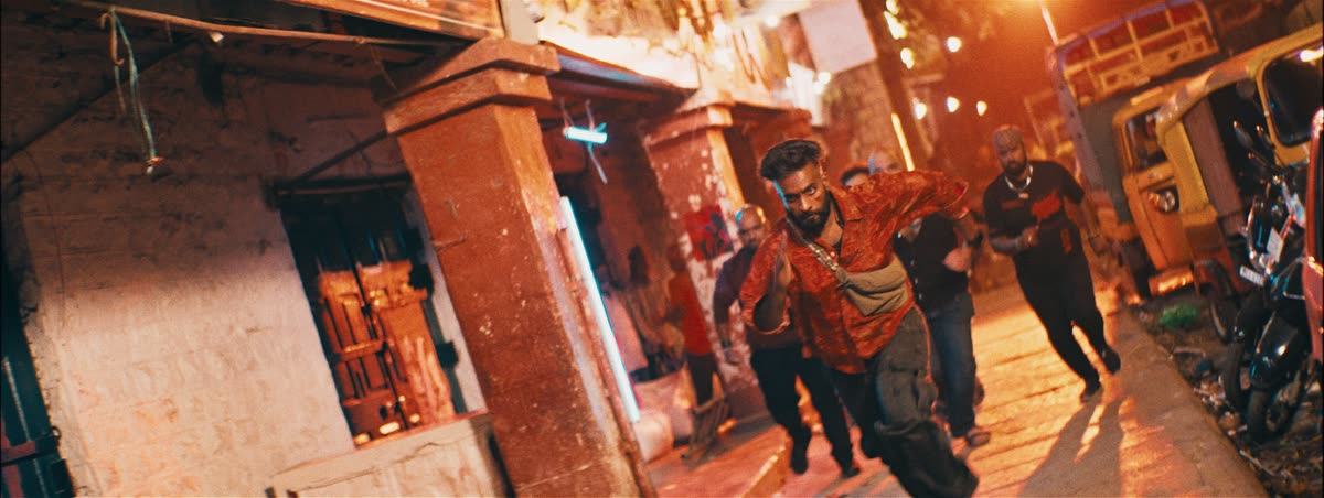 A chase through an orange-lit street